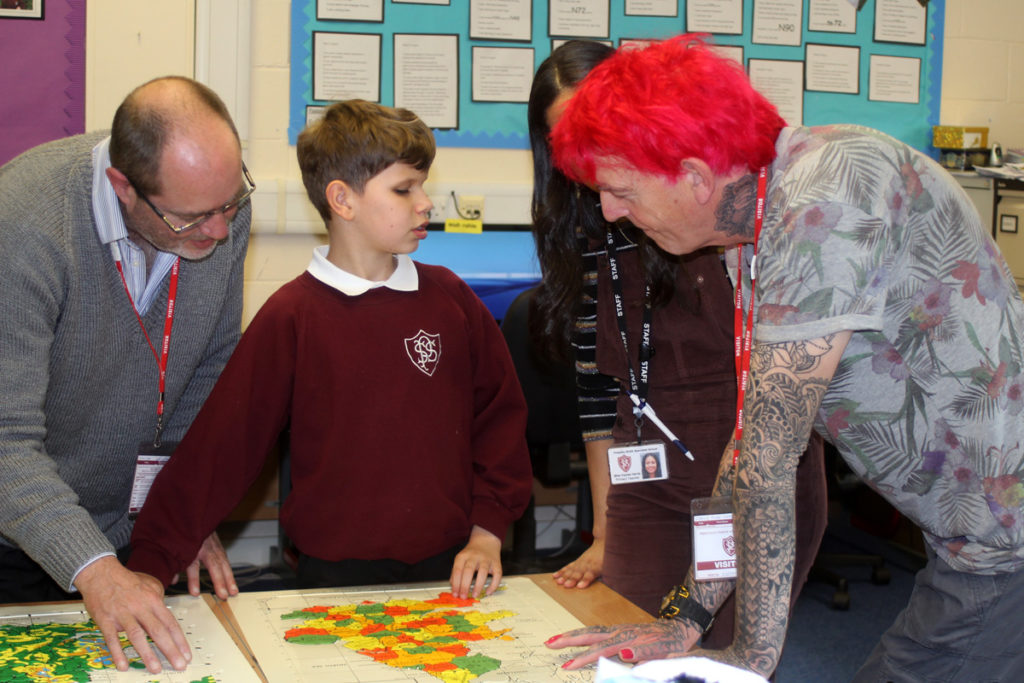 Alan and the children looking at the braille map