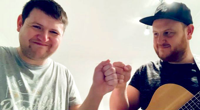 Scotty and Liam 'fist bumping' and smiling
